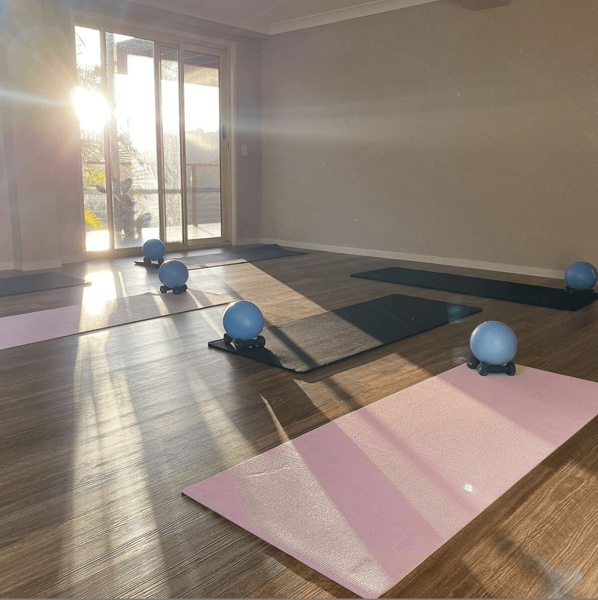 A comfortable sunny room with pilates mats and props at Valley Pilates studio.